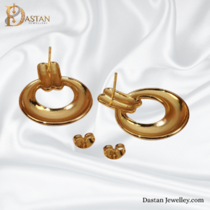 close-up of gold circular stud earrings showing polished finish