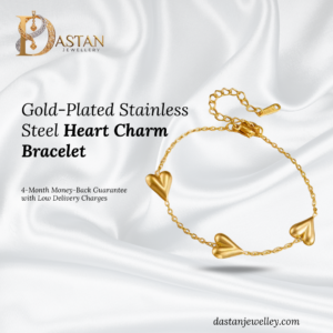 Heart charm bracelet worn on wrist showing delicate gold chain and shine.