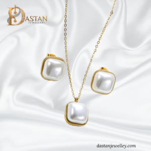 Close-up of pearl-look square locket with golden edge and shine