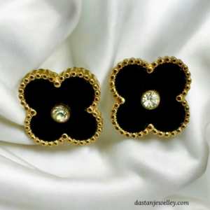 Close-up of black clover stud showing gold edging and sparkling centre