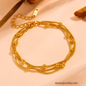 Close-up of bead accents on Triple Chain Bead Bracelet gold finish