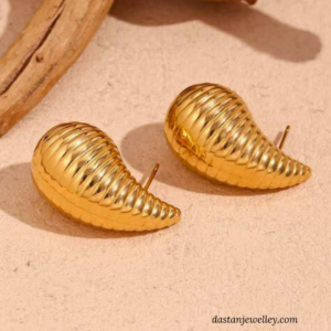 Close-up of Golden Shell Hoop Earrings showing ribbed, sculpted texture details